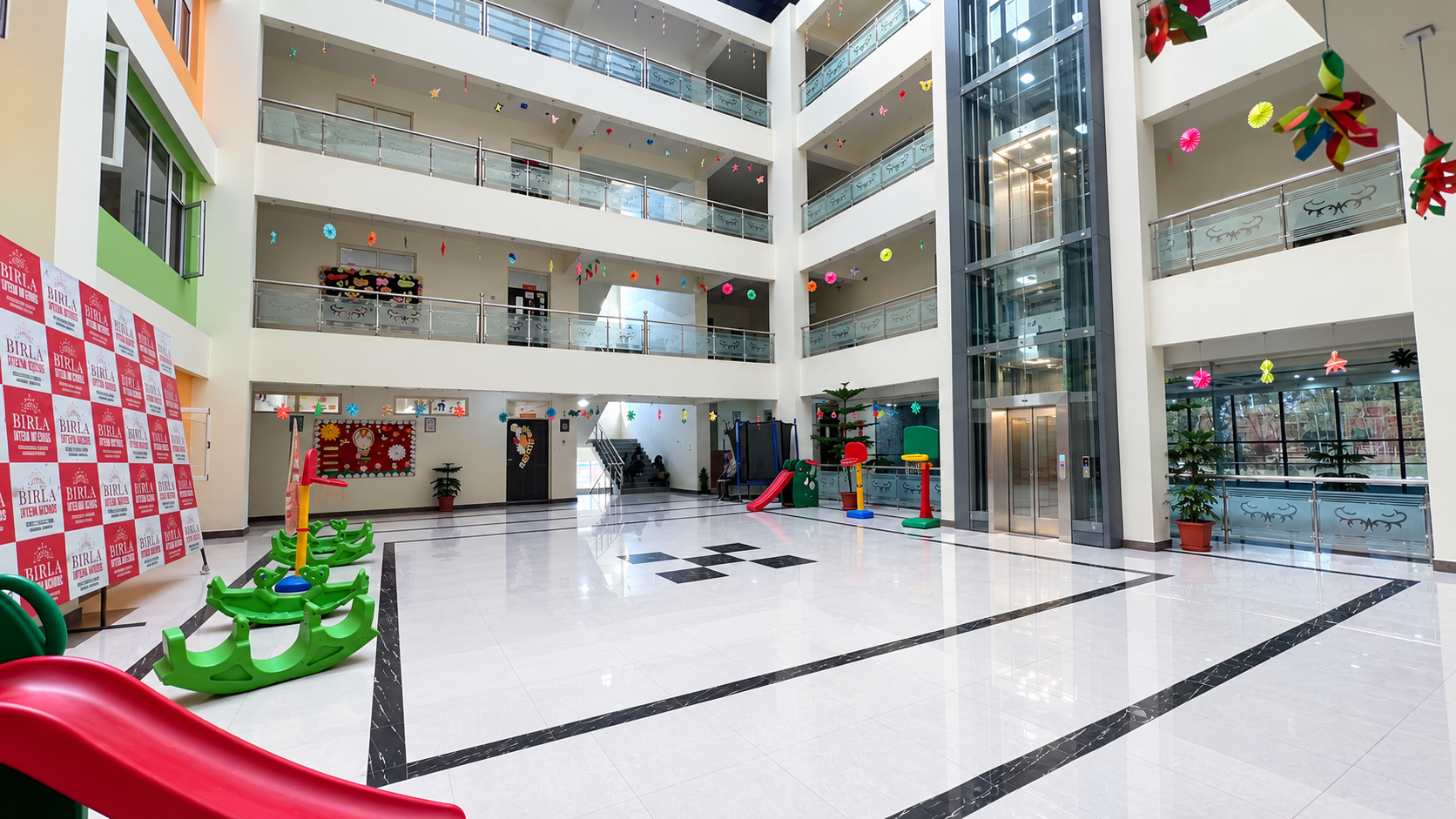 Multi-storey atrium and indoor play area inside Birla Open Minds International School, HMT Srinagar